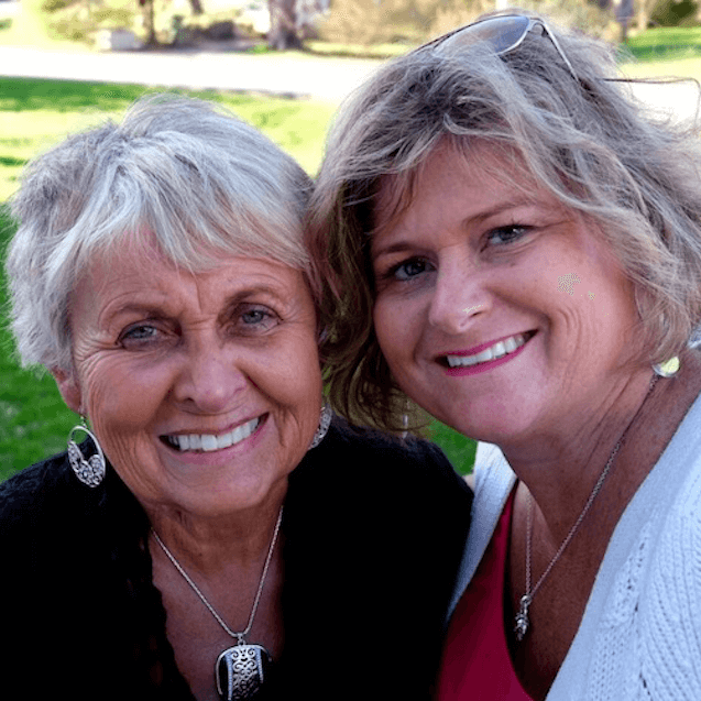 A mother and daughter discuss assisted living outside together.