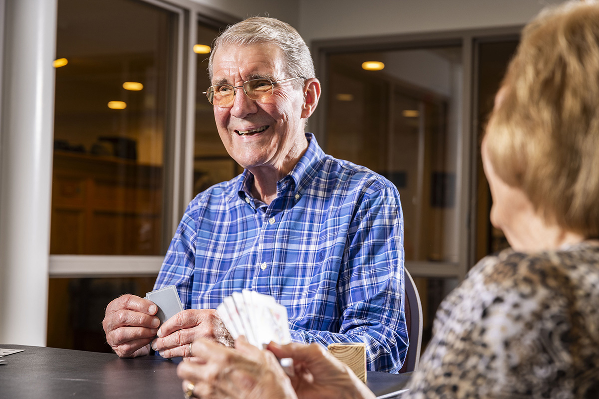 A resident enjoys a card game at Willow Brook in Delaware, Ohio, capturing the social side of life enrichment programming.