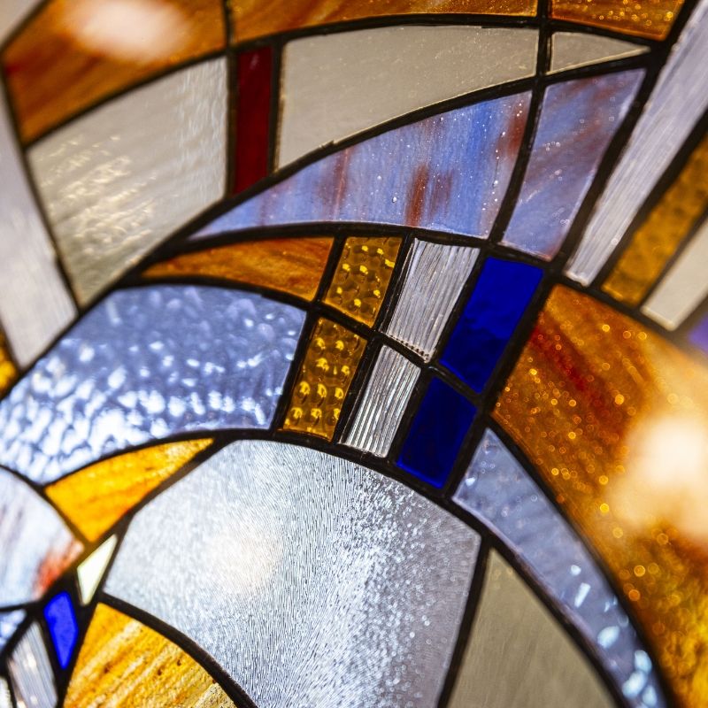 Stained glass detail used as the mobile header for the Willow Brook blog page, illustrating the community's faith-centered roots in Delaware, Ohio.