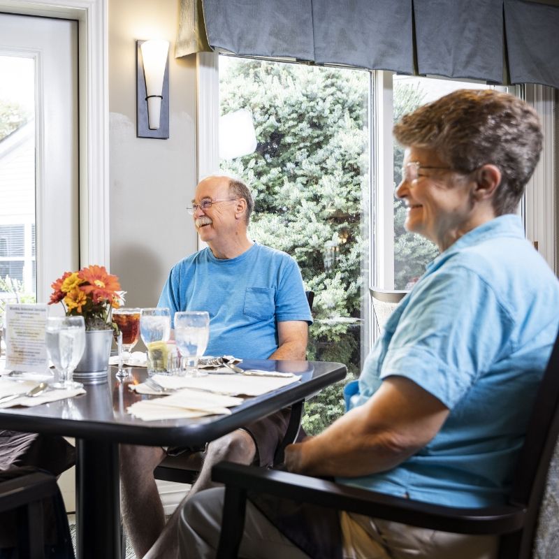 Two friends share a meal at the Village dining room at Willow Brook in Delaware, Ohio, illustrating the social side of senior dining.