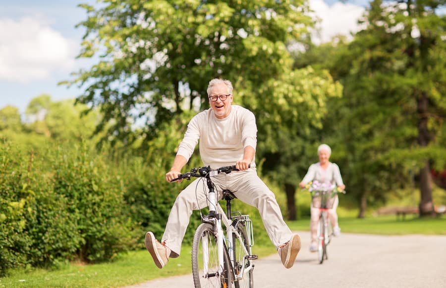 Senior couple riding bikes outdoors